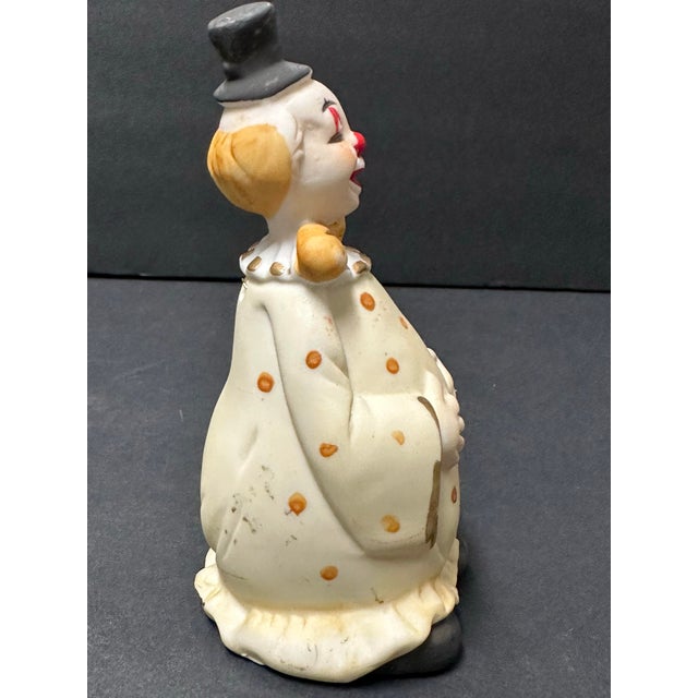 Vintage clown bell with black top hat, yellow polka dot outfit, red nose and hand-painted details. Measures 2” x 2” x 5”.