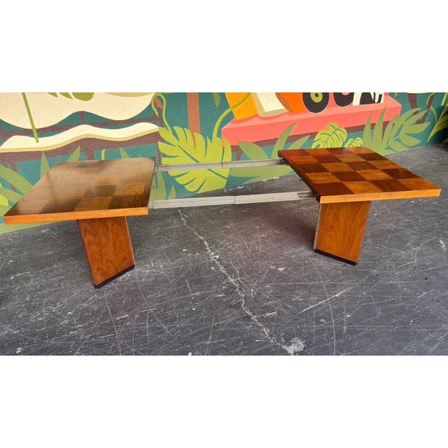 Brutalist style Lane Staccato dining table with two leaves. Parquetry top and angled collapsible pedestals. Can complement...