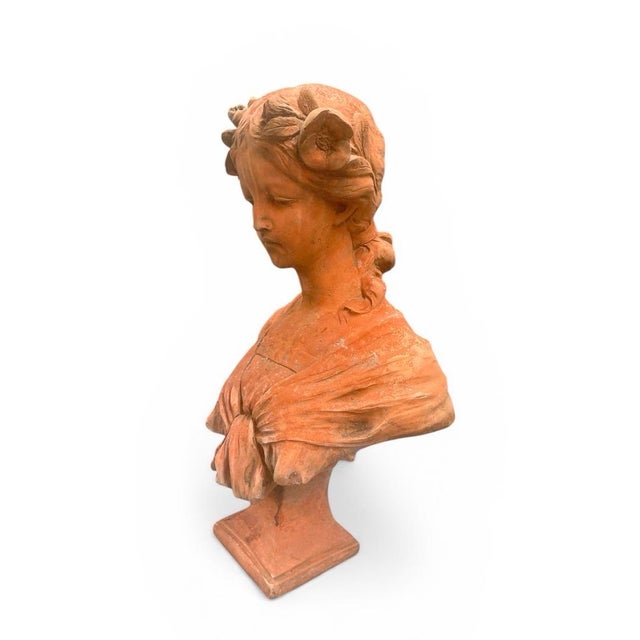 Capture the timeless beauty of classical sculpture with this exquisite vintage terracotta bust. The piece features a...