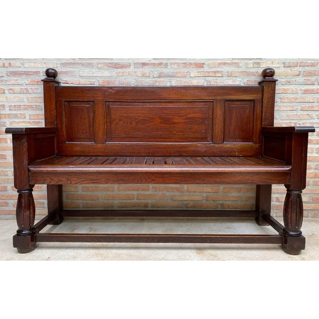Impressive antique Spanish bench crafted in solid oak, featuring a strong architectural design characteristic of...
