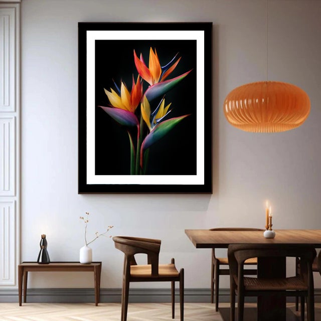 A vibrant cluster of Bird of Paradise flowers bursts with fiery reds, golden yellows, and deep blues, dramatically lit...
