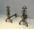 This very interesting pair of design andirons is made of brass and wrought iron. This is a french work in the style of...