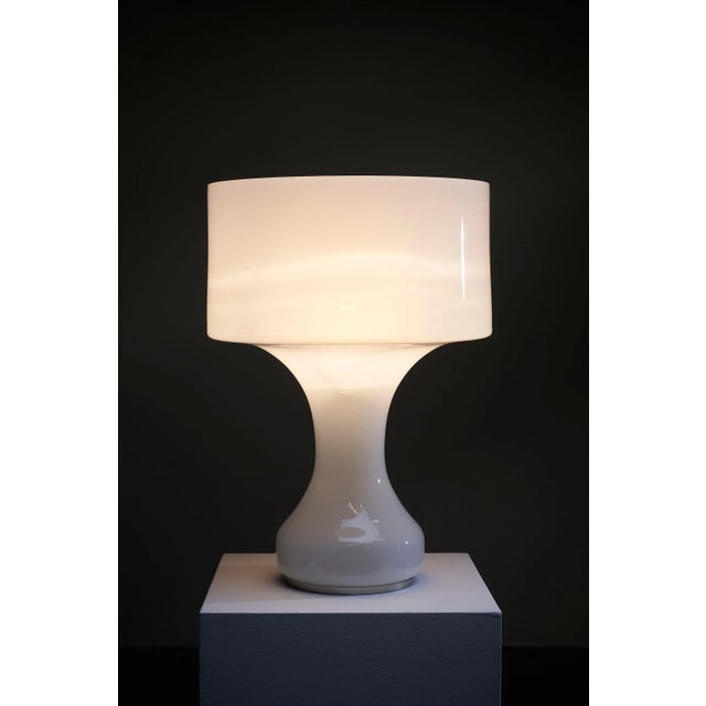 Introducing the "l190 sebenica" table lamp, a captivating creation designed by enrico capuzzo for the esteemed brand...