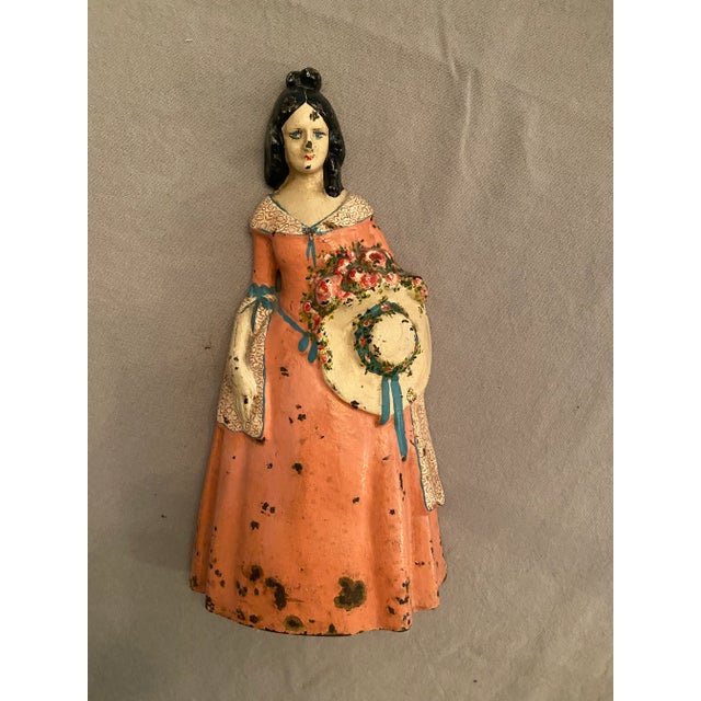 National Foundry antique doorstop of a young lady woman Southern Belle holding a hat and flower bouquet. Cast Iron with a...