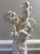 An antique Chinese blanc de Chine porcelain figure of Guanyin, circa 1930. The white porcelain figure stands with raised...