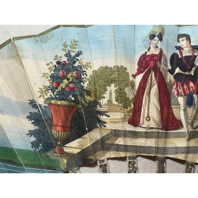 Step back in time with this exquisite antique hand fan, a true testament to the artistry of France in the early 19th...