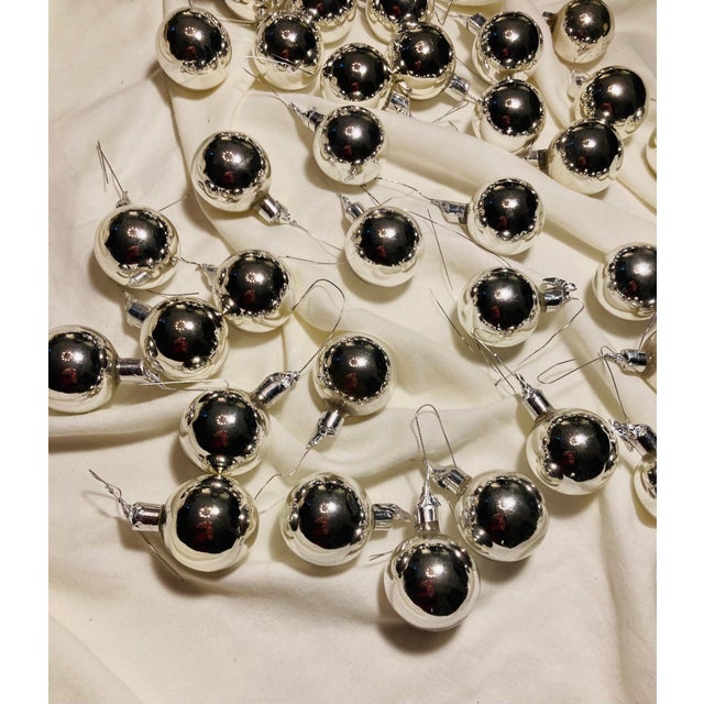 Big collection of gleaming silver mercury glass medium sized balls