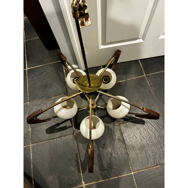 Elevate your space with this striking mid-century modern 5-light saucer-style chandelier. This fixture beautifully blends...