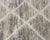 Lines converging like paths across sun-worn stone. Crisp ivory diagonal lines cross and intersect across a richly mottled...
