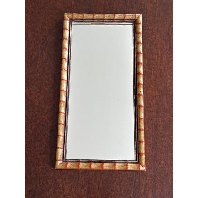 This faux bamboo mirror with its warm golden coloring and touch of red is wonderful for anyone who appreciates a touch of...