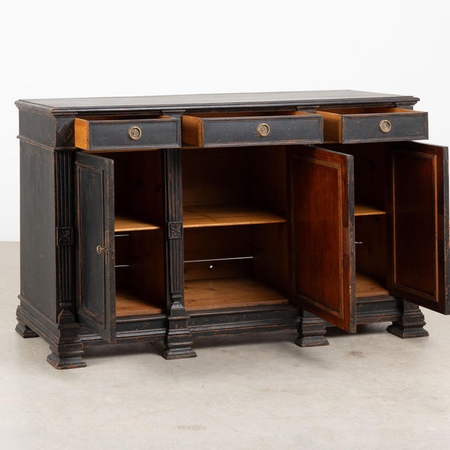 19th century Swedish Gustavian sideboard, crafted in pine. The cabinet features a three drawer over three door...