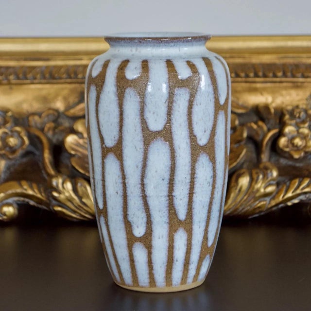Striking vintage Japanese stoneware vase featuring a dramatic drip glaze design with cascading white glaze over a warm...