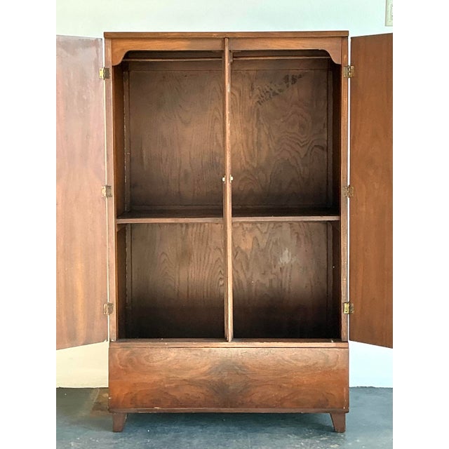 This stunning vintage armoire is a masterclass in organic texture and mid-century sophistication. The piece is defined by...