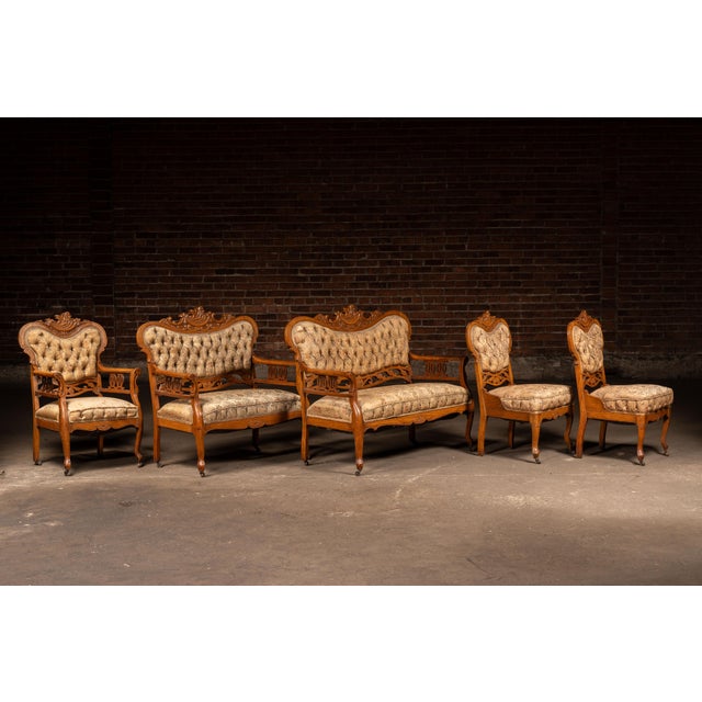 Six-piece parlor suite in solid oak featuring hallmark Eastlake and late Victorian design elements, including deeply...