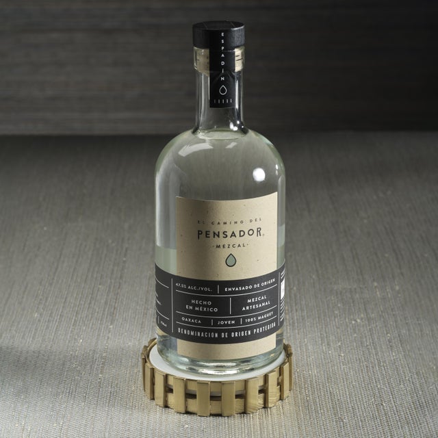 Balancing modern elegance with natural sophistication, this round stainless steel wine bottle coaster features a matte...