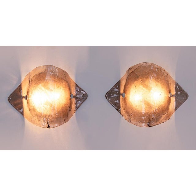 Elegant pair of kalmar wall sconces made of handblown smoked / amber murano glass mounted on white back plates. Made in...