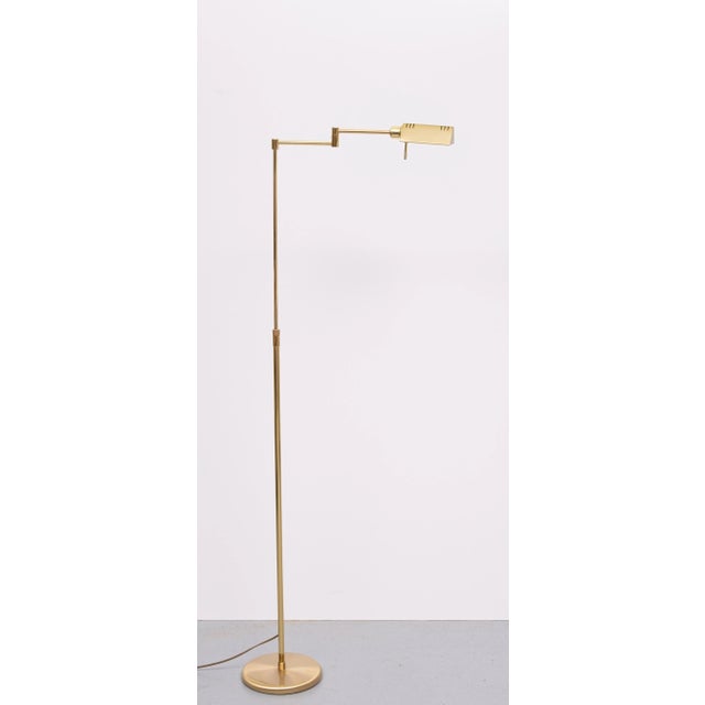 Very nice swing arm Brass floor lamp .adjustable in height . Halogen . Comes with a good working dimmer on the shade ....