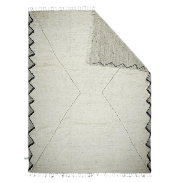 Comprising both the nomadic Berber rugs of the Atlas Mountains, with very thick piles, coarse knotting and limited...