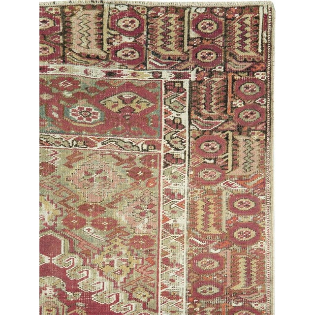An early 20th century Turkish Ghourdes carpet. This antique Ghourdes rug offers a fire brick central field of leafy...
