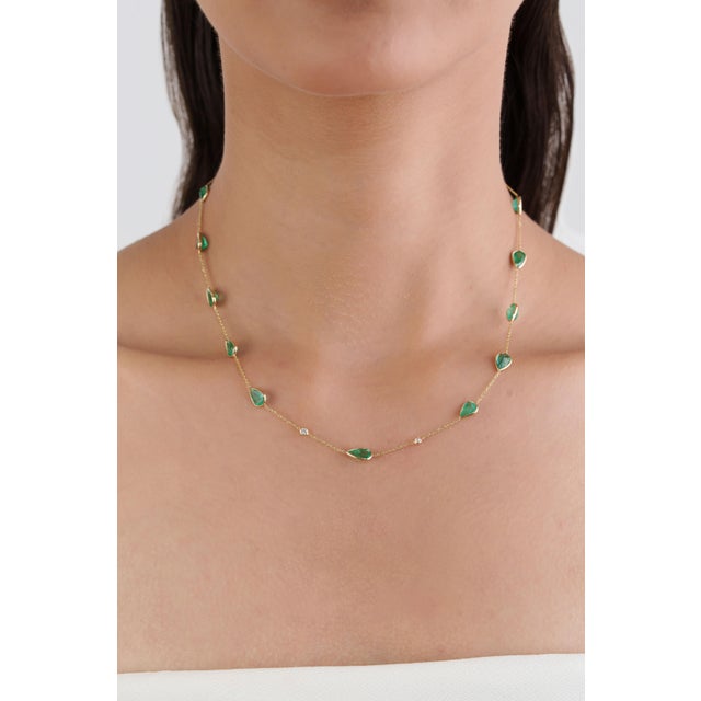 This station chain necklace features 6.84 ct of natural pear-cut emerald, set in 14K yellow gold. The green stones measure...