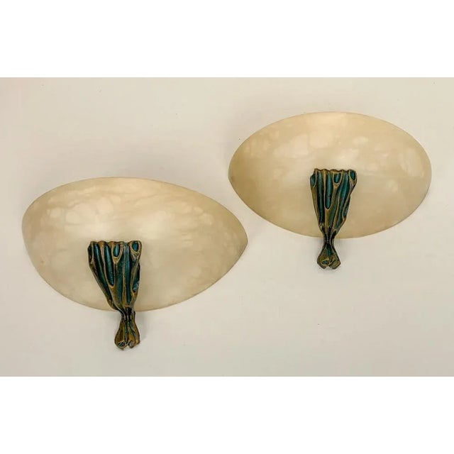 A set of beautiful Spanish Alabaster wall lamps with green-gold accent decoration. Both burning and not in operation a...