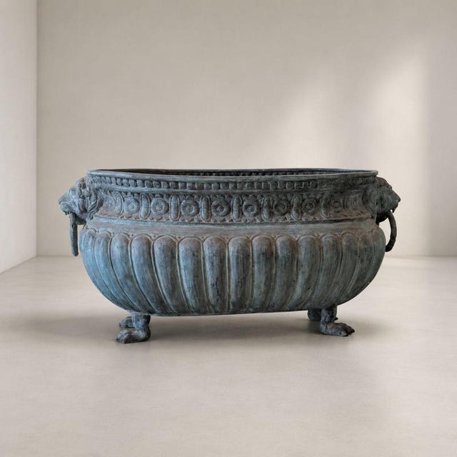 An important early 20th-century Italian cast bronze flowerpot, characterized by a monumental oval shape and a rich...