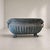 An important early 20th-century Italian cast bronze flowerpot, characterized by a monumental oval shape and a rich...