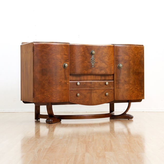 This vintage cocktail cabinet credenza was designed and manufactured by Beautility Furniture in England during the 1950s....