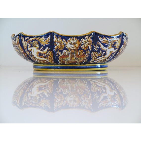 An absolutely stunning c1860 faience renaissance motif bowl by gien. The bowl features a striking motif of scrolling...