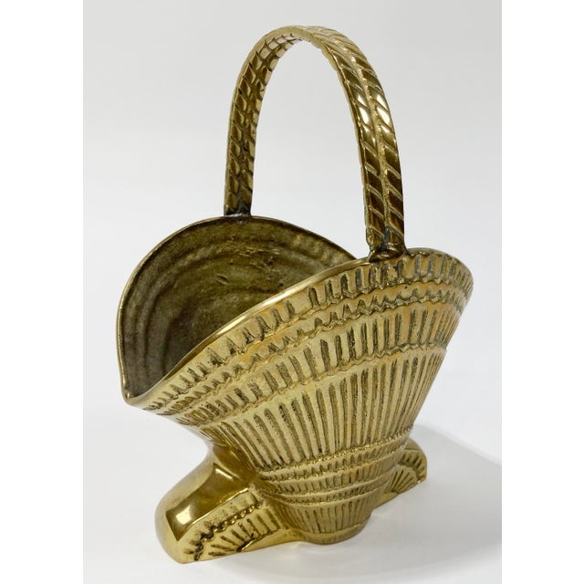 Vintage heavy brass clamshell motif basket planter with rope detailed handle. Sits on solid brass base. A whimsical...
