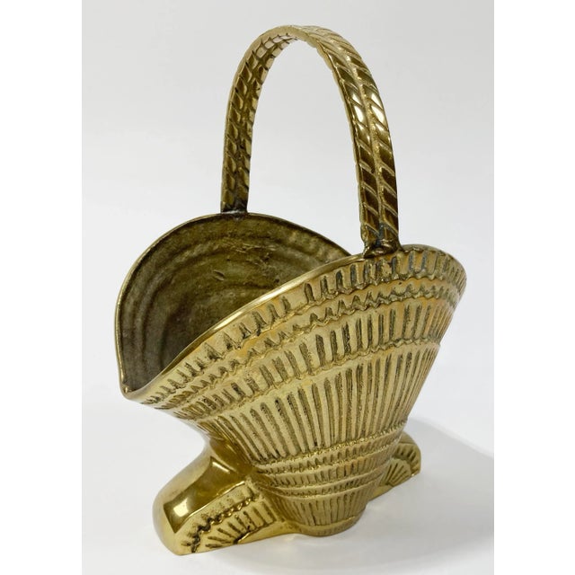 Vintage heavy brass clamshell motif basket with rope detailed handle. Sits on solid brass base. A whimsical addition to...
