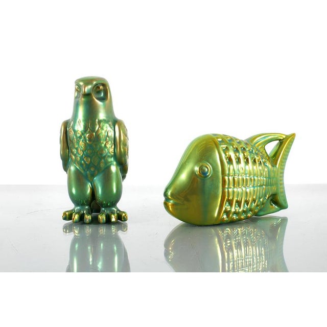 Set of two Art Déco miniatures, in the shape of an eagle and a fish, in porcelain hand-glazed with iridescent eosin green....