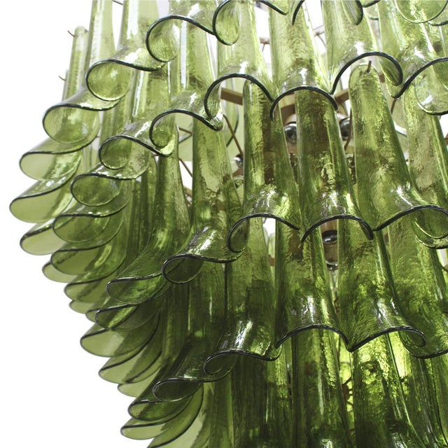 Suspension lamp composed of over 100 individually handcrafted petal-shaped elements in green Murano glass. The petals are...