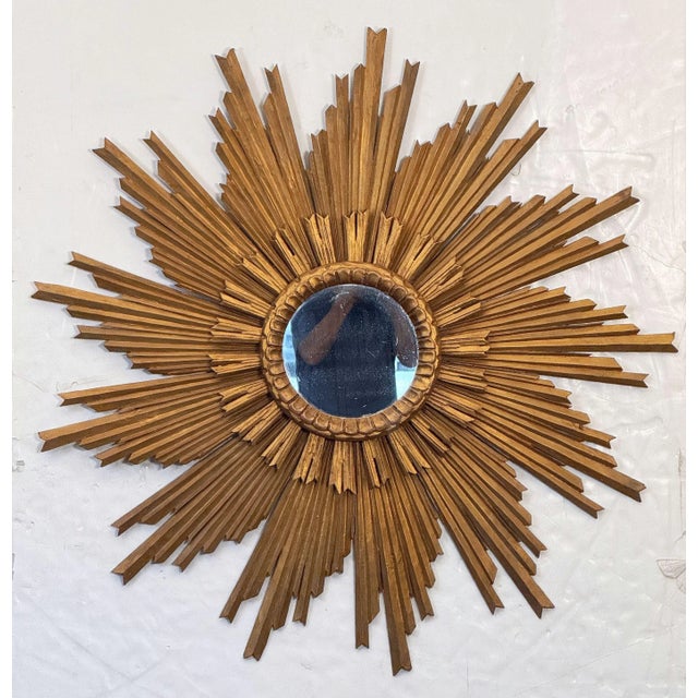 A beautiful large French gilt sunburst (or starburst) mirror in a lovely moulded giltwood frame, featuring a multi-level...