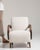 This mid 20th century armchair from Czech Republic is finished in ivory, worked in wood. Its upholstered detailing gives...