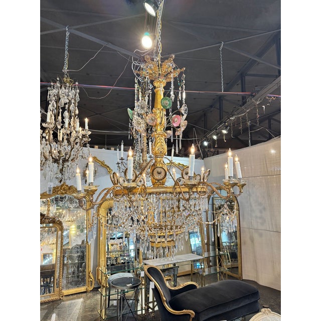 This 19th c. Italian Tuscan Giltwood and Crystal Chandelier is a stunning and elegant lighting fixture. Featuring a gold...