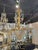This 19th c. Italian Tuscan Giltwood and Crystal Chandelier is a stunning and elegant lighting fixture. Featuring a gold...