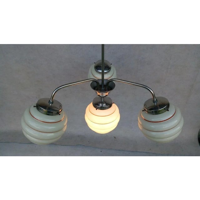 Beautiful authentic art deco chandelier. Holder original nickel-plated, cleaned, with preserved patina. 4 light elements...