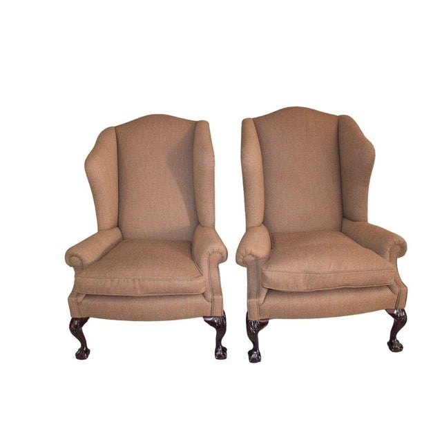Set of two George Smith Ltd. Wingback Chairs upholstered in classic tan upholstery, showcasing timeless English design and...