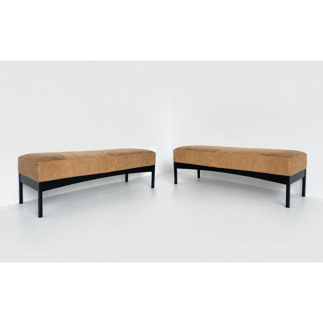 Unique vintage bench in light cognac with aged-texture Alcantara upholstery. The frame features wooden sides and metal...