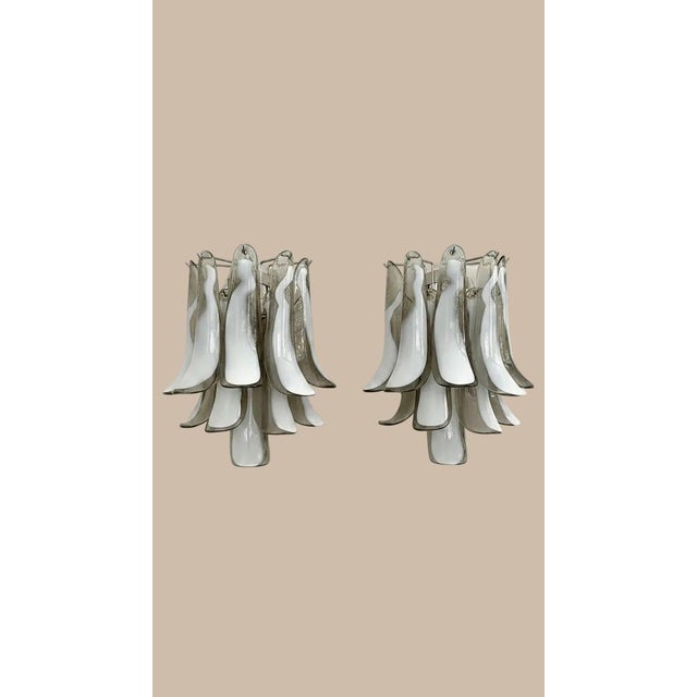 DUTIES FREE Elegant pair of hand-blown Murano glass wall sconces featuring a refined combination of smoked and lattimo...