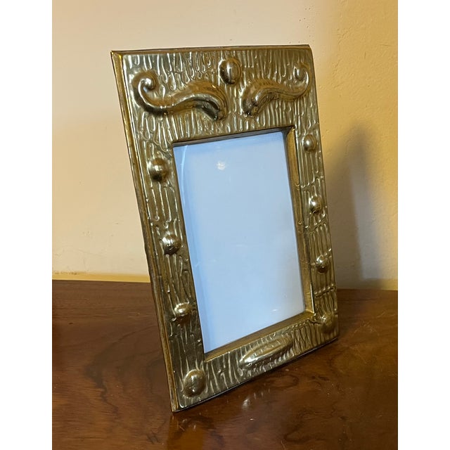 Antique early 20th century Art Nouveau brass photo frame. Relief tooled design in the Aesthetic taste. Measures 8 7/8" x 6...
