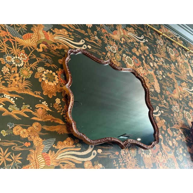 A charming vintage mirror featuring a sculptural scalloped frame with a warm amber-brown finish. Its elegant shape and...