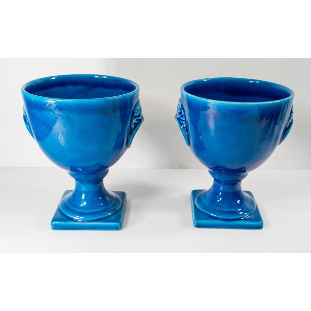 We are selling this pretty pair of vibrant blue turquoise color glazed urns which are signed Italy. Great for a mantle as...