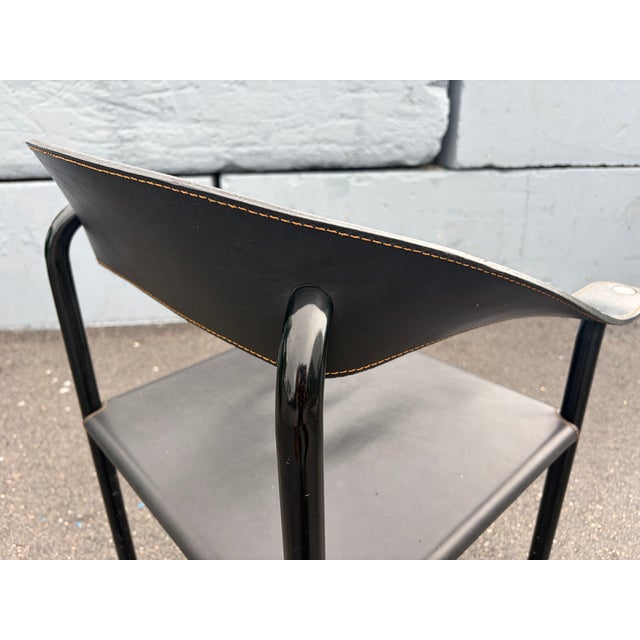 One Artelano Black Leather Arm Side Chair, Italy 1980s. Steel frame with black finish and black leather. We also have a...