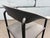 One Artelano Black Leather Arm Side Chair, Italy 1980s. Steel frame with black finish and black leather. We also have a...