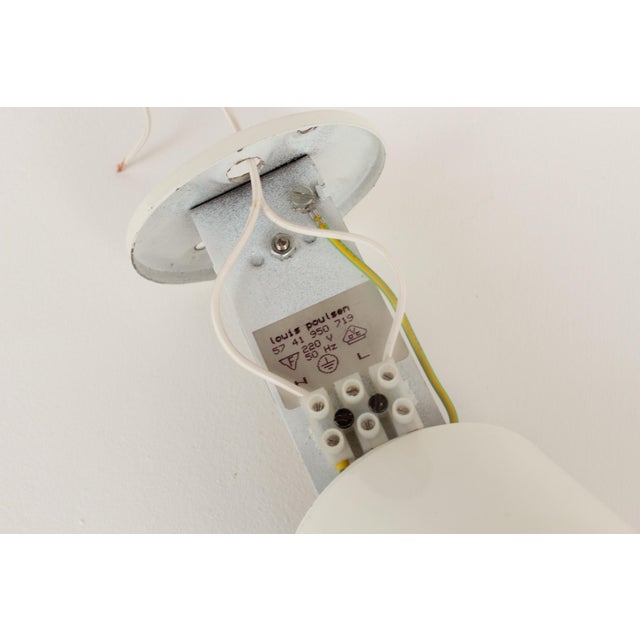 Louis poulsen pendant lamp. manufactured in west germany in the 1980s. white lacquered metal, transparent screw-on glass...