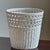 Offering a lovely white wicker wastepaper basket — beautifully hand-woven in the mid-20th century with careful attention...