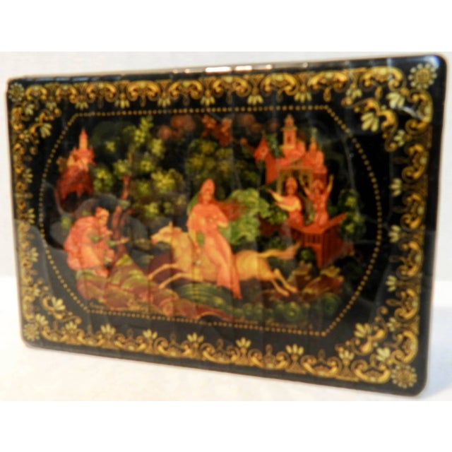 This is a vintage Russian black lacquer box that features dancing Fairies on the top. The borders have a dainty gold...