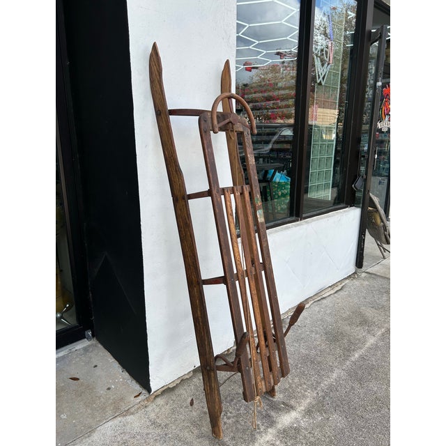 Impressive, 19th century German sled with steering wheel, brakes, wood runner, and metal hardware.